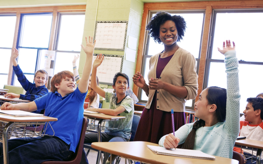 Teacher smiles at class full of students