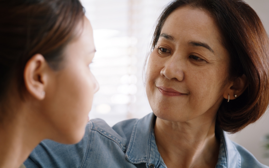 Mother smiling and comforting her daughter.