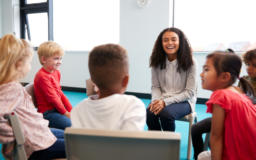 Teacher engages a small elementary class in a circle disc