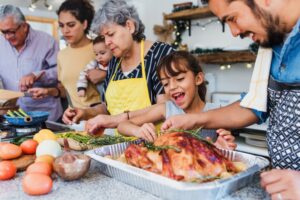 Multigenerational family preparing a meal together in the kitchen.