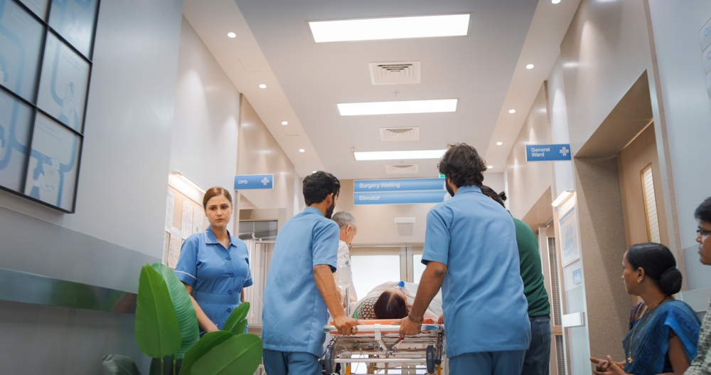 Backview,Shot,Of,Group,Of,Medical,Specialists,Transporting,An,Elderly