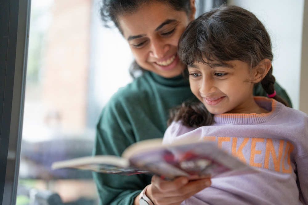 Mother,And,Daughter,Reading,Book,Near,Window