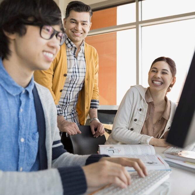 High,School,Students,And,Teacher,In,Computer,Lab
