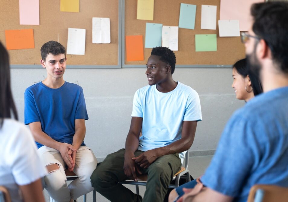 Teenager,Student,Talking,With,Teacher,And,Classmates,-,Group,Discussion