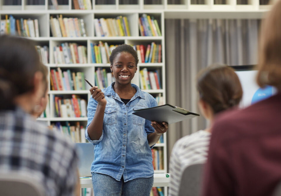 Smiling,Young,African,Woman,Presenting,Her,Report,To,The,Young